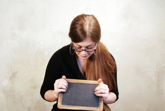 Young Woman holds a Chalkboard