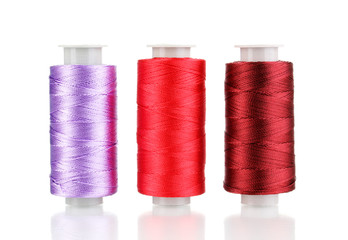 Three bobbin thread isolated on white