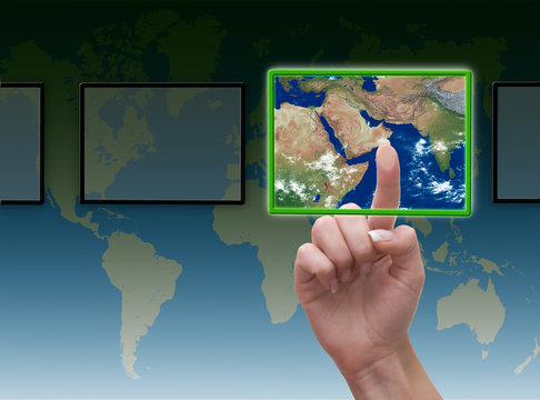 Hand pressing touchscreen button on the world background