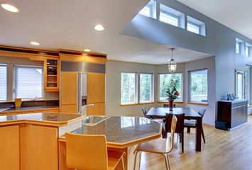 Large luxury modern wood kitchen with granite counter tops.