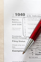 Obraz premium Tax form and a red pen