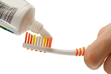Toothbrush and toothpaste in female hands