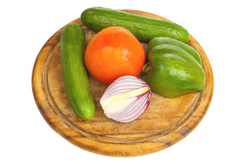 Pepper, onion, cucumber and tomato on a desk