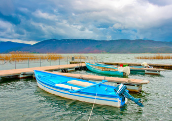 Fototapeta na wymiar Old wooden fishing boats in the lake Prespa in Greece.