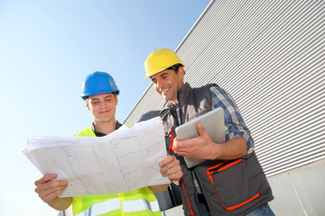Young people in professional training on industrial site