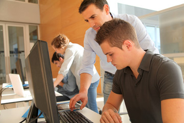 Educator helping student in training class