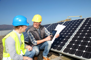Man showing solar panels technology to student girl