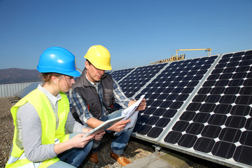 Man showing solar panels technology to student girl