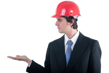 Young engineer with red helmet holding imagined object