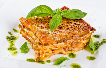 Closeup of lasagna and basil fork