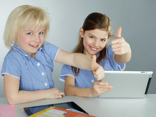 Girls shows thumbs up for learning by mobile device
