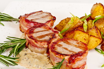 Grilled steak wrapped in bacon, with grilled vegetables