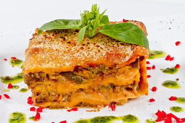 Closeup of lasagna and basil fork