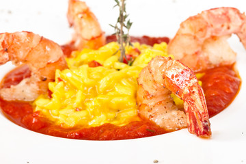 Plate of Shrimps Risotto garnished with fresh parsley and Parmes