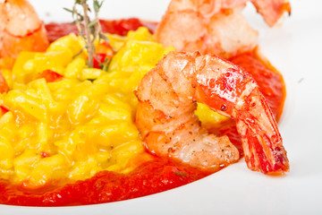 Plate of Shrimps Risotto garnished with fresh parsley and Parmes