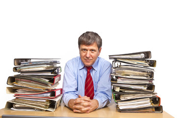 man studies folder with files at his desk in the office