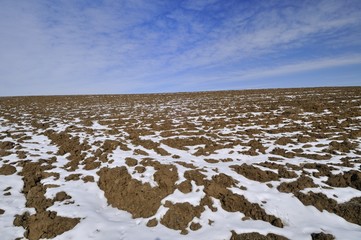 Field on the slope covered with snow