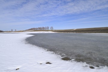 Bottom of the drained lake during a snowy season