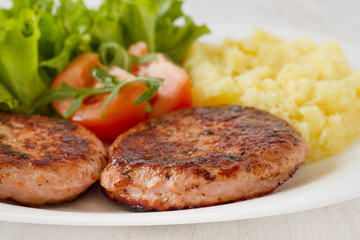 grilled turkey hamburgers with mashed potato and salad