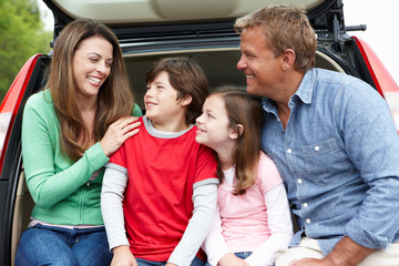 Family outdoors with car