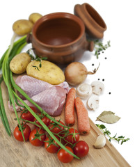 Ingredients for a roast chicken in a pot : chicken, potatoes, ca