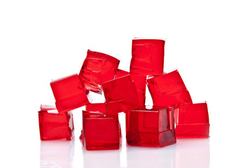 Cubes of red jelly on a white background - obrazy, fototapety, plakaty