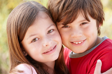 Portrait hispanic brother and sister outdoors