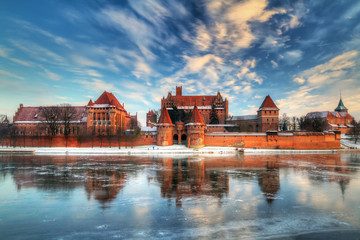 Teutonic castle in Malbork with frozen Nogat river, Poland