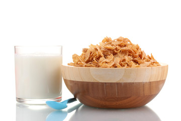 tasty cornflakes in wooden bowl and glass of milk isolated