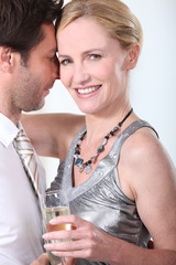 Man and woman in a clinch, dancing and drinking champagne