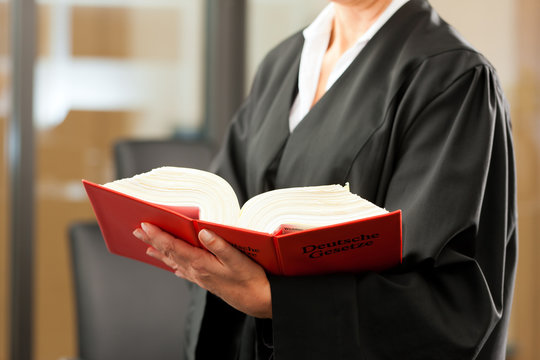 Anw&auml;ltin mit Gesetzbuch und Robe