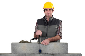 Bricklayer with a plumb line