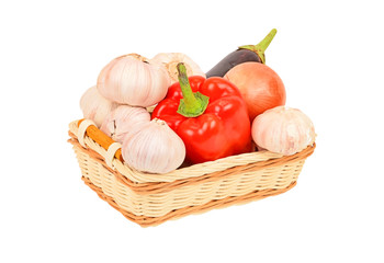 Vegetables in a wattled basket, isolated on white background