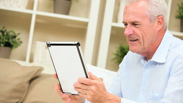 Senior Male Using Wireless Tablet Technology