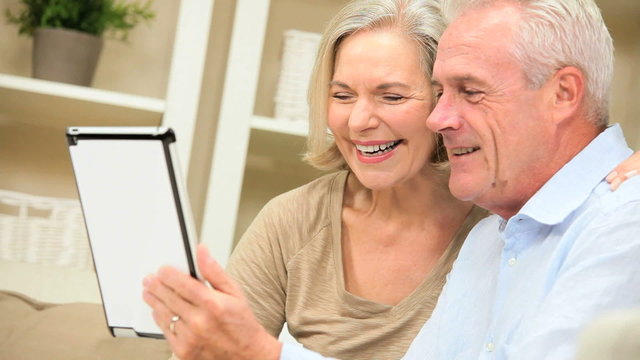 Mature Caucasian Couple Using a Wireless Tablet at Home