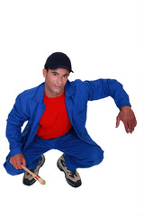 A painter leaning on an invisible something.