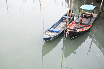 two fishing boats anchor in the dock