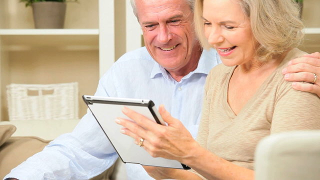 Retired Couple Using Wireless Tablet Technology