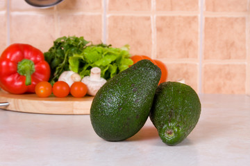 Avocado against fresh vegetables