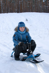 Fototapeta na wymiar Cheerful boy walks in winter park