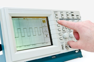 Engineer Operating a Digital Oscilloscope