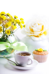 breakfest with tea, cake and yellow flowers