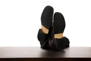 Successful businessman relaxing over desk, isolated in white bac