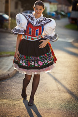 young woman in a richly decorated ceremonial folk dress