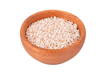 Wheat in a wooden bowl, isolated on white background
