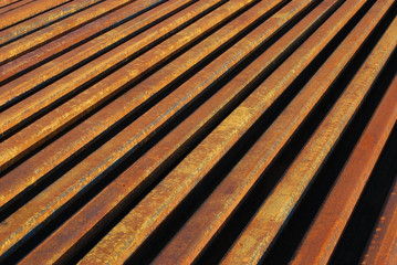 Rusty rails lined-up close as background perspective
