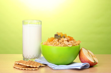 tasty cornflakes in green bowl, apple and glass of milk