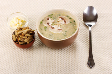 Tasty soup on beige tablecloth
