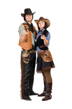 Young cowboy and cowgirl with a guns
