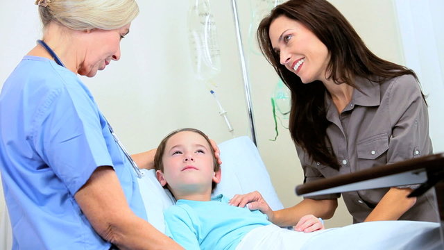 Mother and Nurse Reassuring Little Boy in Hospital